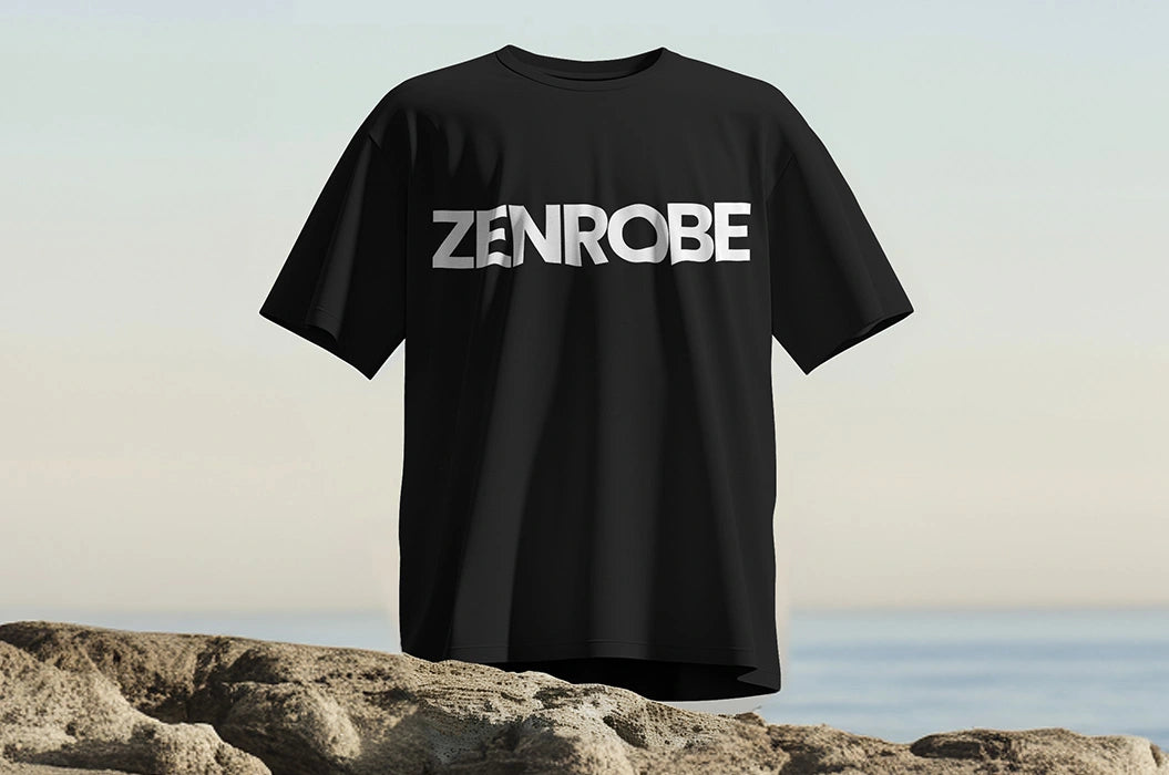 A minimalistic black t-shirt displayed on rugged terrain, featuring the 