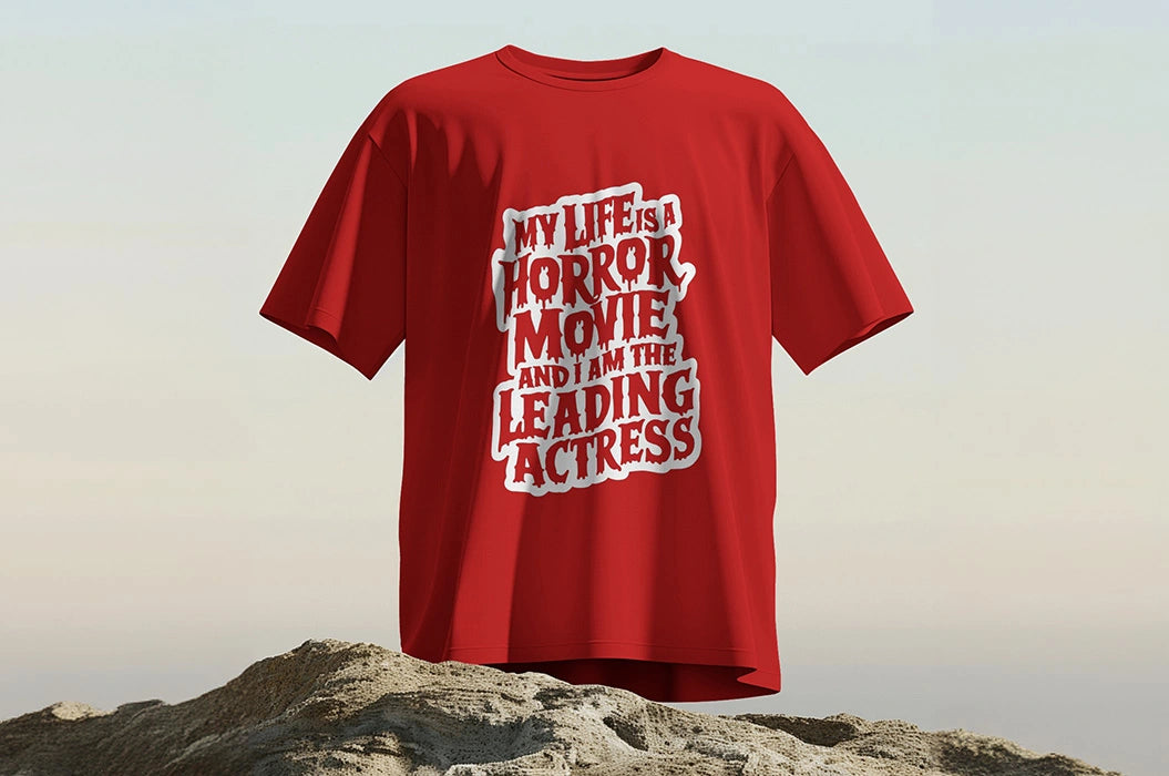 A red t-shirt displayed on rocky terrain with the text, 