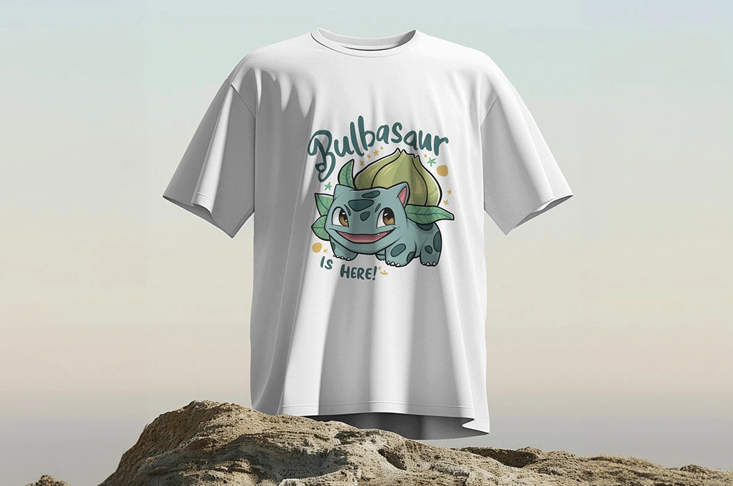 A white t-shirt on rocky terrain showcasing a vibrant illustration of Bulbasaur with the text, 